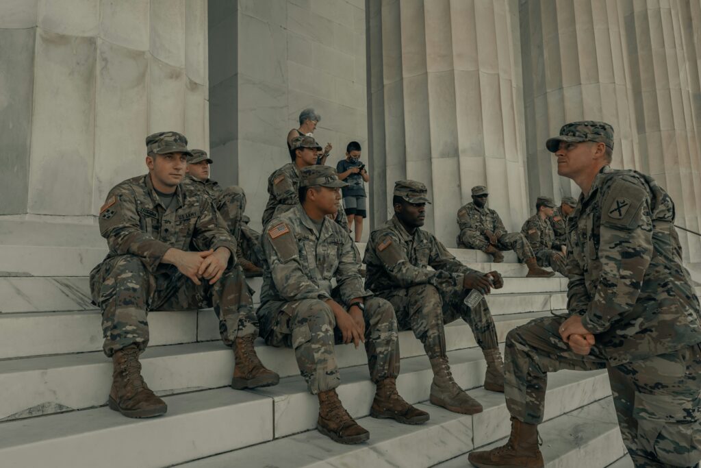 Soldiers sitting on the steps of a monumnet