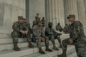 Soldiers sitting on the steps of a monumnet